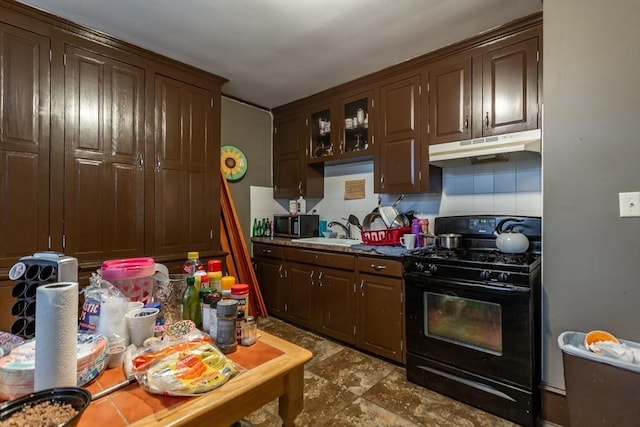 kitchen featuring dark brown cabinets, sink, decorative backsplash, and black appliances