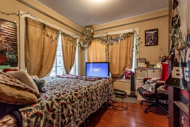 bedroom with crown molding and wood-type flooring