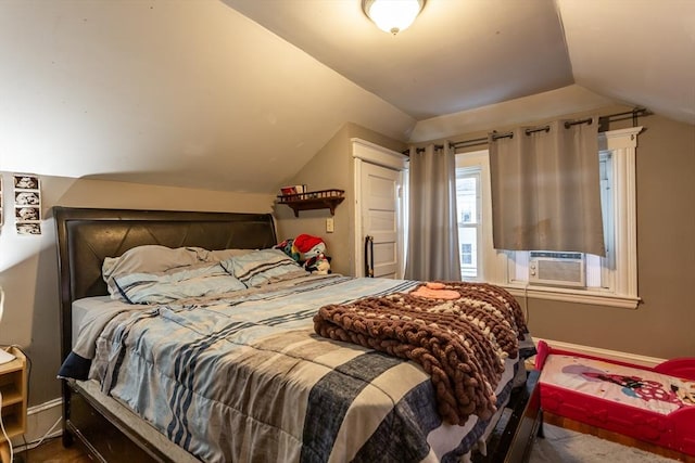 bedroom with cooling unit and vaulted ceiling