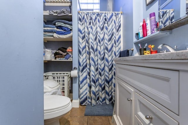 bathroom with tile patterned floors, toilet, and walk in shower