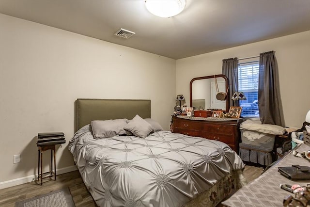 bedroom with dark hardwood / wood-style flooring