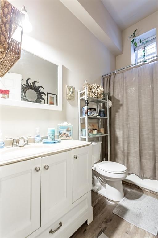 bathroom featuring hardwood / wood-style flooring, vanity, and toilet