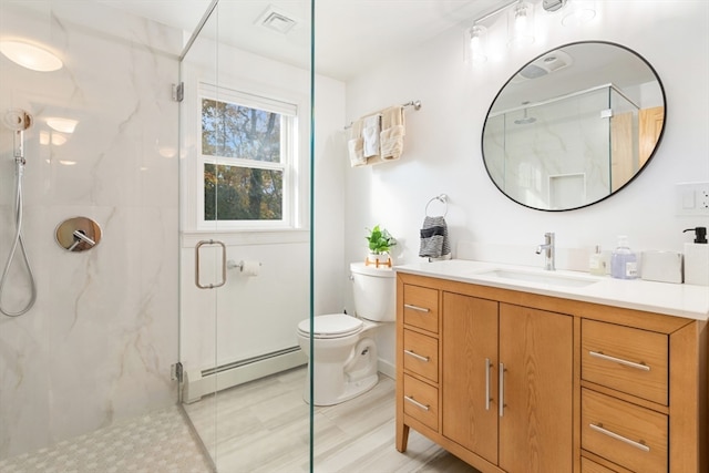 bathroom featuring vanity, toilet, an enclosed shower, and baseboard heating