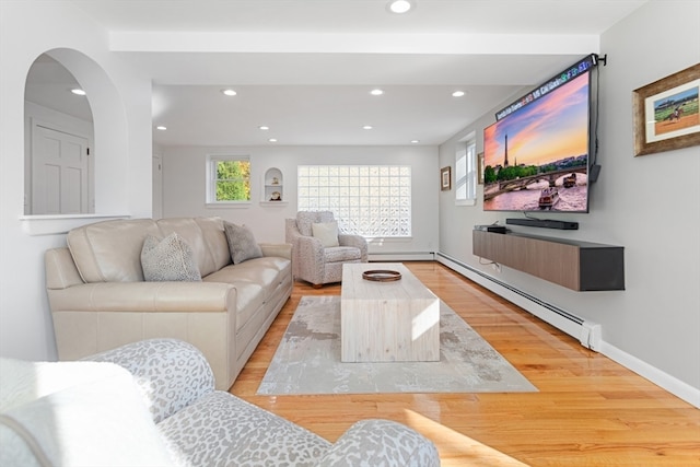 living room with light wood-type flooring and baseboard heating