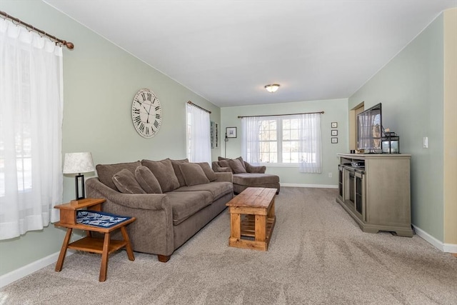 living room featuring light carpet and baseboards