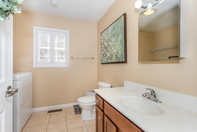 bathroom featuring tile patterned flooring, toilet, vanity, visible vents, and baseboards