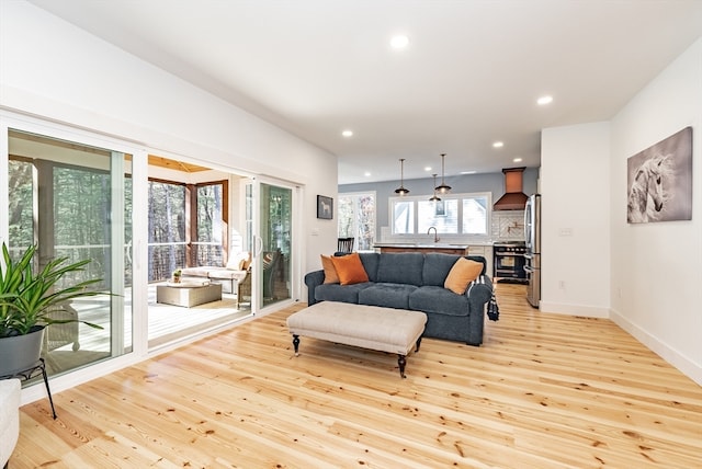 living room with sink and light wood-type flooring