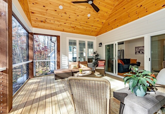 sunroom / solarium featuring ceiling fan, wood ceiling, and vaulted ceiling