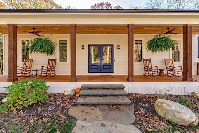 view of exterior entry featuring covered porch, french doors, and ceiling fan