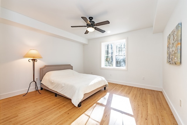 bedroom with hardwood / wood-style floors and ceiling fan