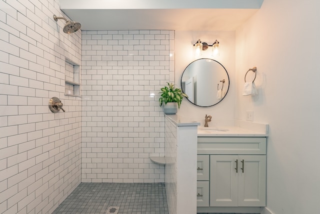 bathroom with vanity and a tile shower