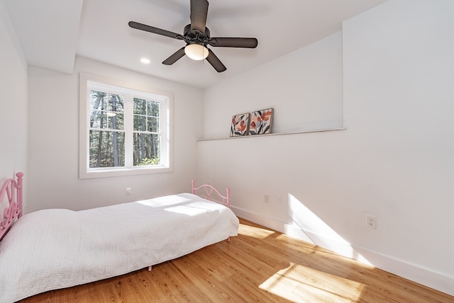 bedroom with ceiling fan and wood-type flooring