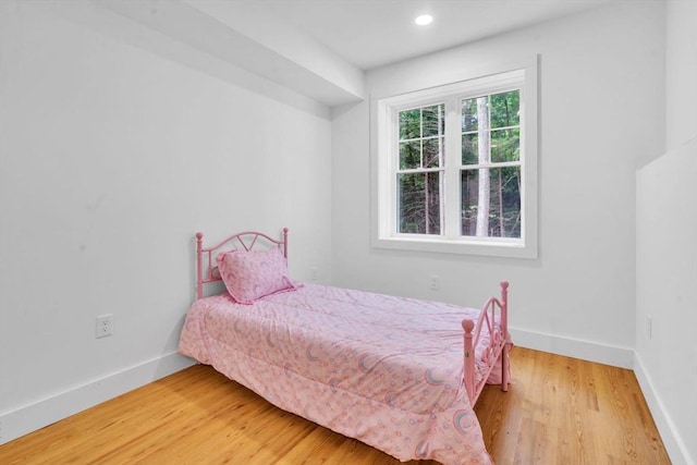 bedroom with hardwood / wood-style floors