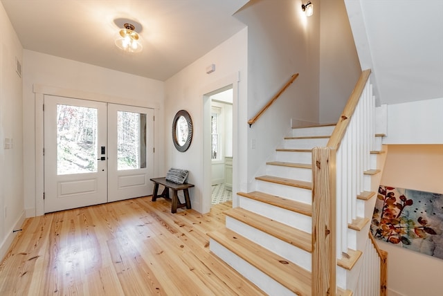 foyer entrance with french doors and light wood-type flooring