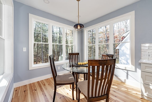 dining area featuring plenty of natural light and light hardwood / wood-style floors