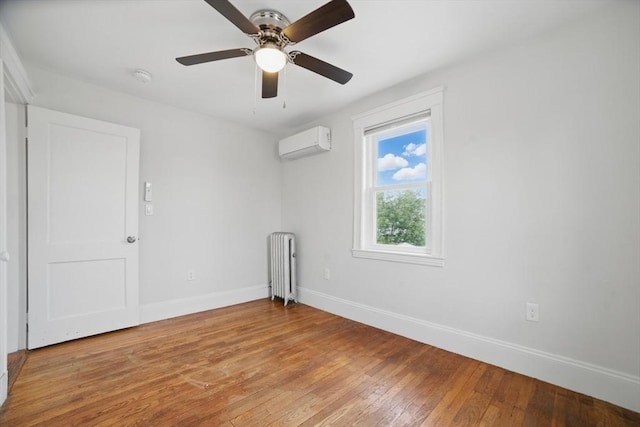 5 Ellington Rd, Quincy, MA 02171 - unfurnished room with radiator heating unit, baseboards, a wall mounted air conditioner, light wood-style floors, and ceiling fan