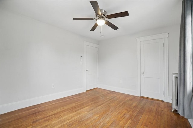 5 Ellington Rd, Quincy, MA 02171 - empty room with light wood-style floors, baseboards, ceiling fan, and radiator