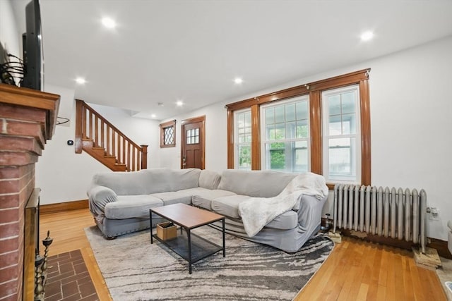 5 Ellington Rd, Quincy, MA 02171 - living room with radiator, hardwood / wood-style floors, stairway, recessed lighting, and baseboards