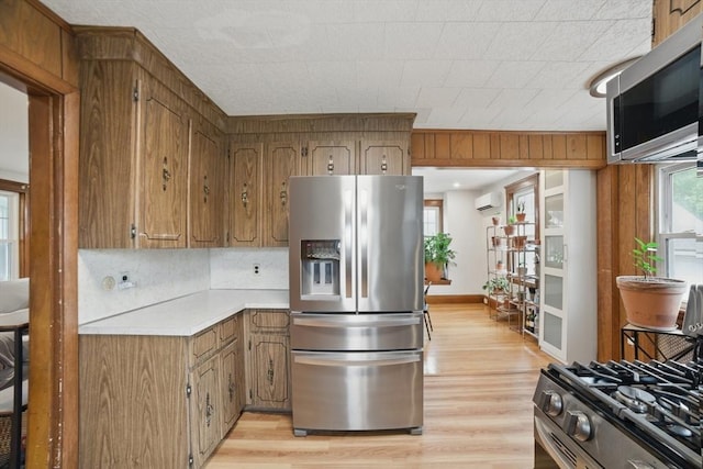 5 Ellington Rd, Quincy, MA 02171 - kitchen featuring stainless steel appliances, a wall unit AC, light countertops, and light wood-style floors