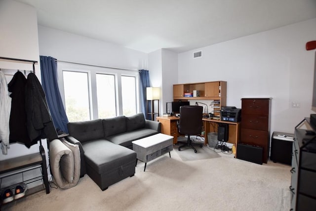 home office with visible vents and light carpet