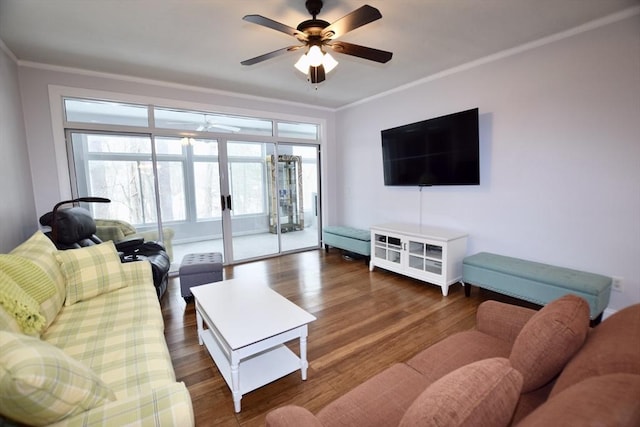 living room with ceiling fan, dark wood-type flooring, and crown molding