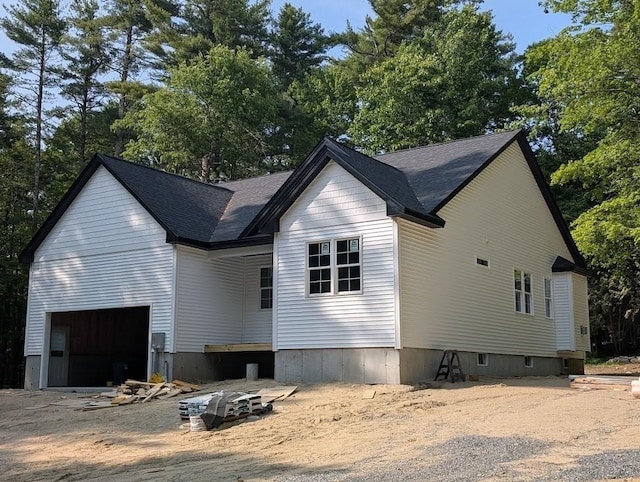 LOT36-13 Adams Rd, Townsend, MA 01469 - view of side of property with a shingled roof, view of scattered trees, and a garage