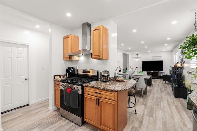 115-117 Clare Ave, Boston, MA 02136 - kitchen with gas range, wall chimney range hood, light wood-style flooring, dark stone counters, and a kitchen breakfast bar