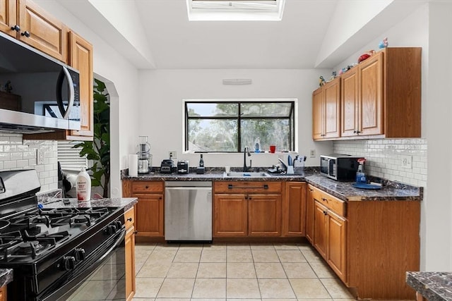 115-117 Clare Ave, Boston, MA 02136 - kitchen featuring stainless steel appliances, a sink, lofted ceiling, tasteful backsplash, and light tile patterned floors