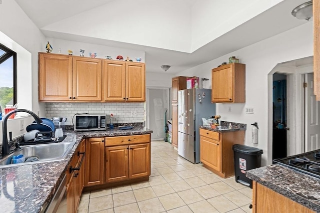 115-117 Clare Ave, Boston, MA 02136 - kitchen with a sink, stainless steel appliances, light tile patterned floors, decorative backsplash, and brown cabinetry