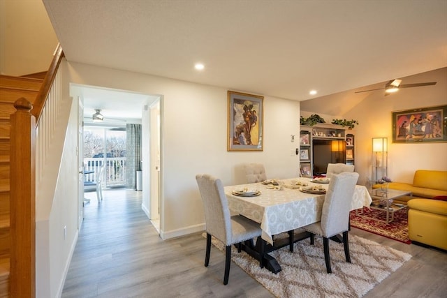 dining space with stairs, light wood-style flooring, a ceiling fan, and recessed lighting