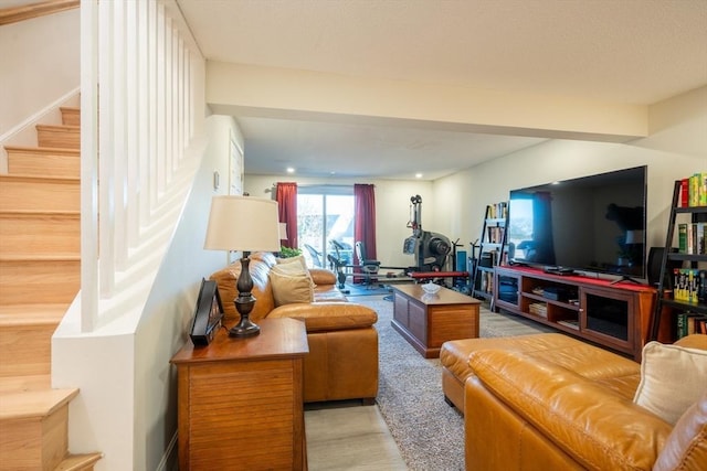 living room with stairs and beam ceiling