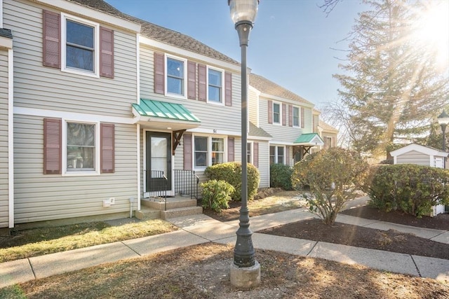 multi unit property featuring roof with shingles