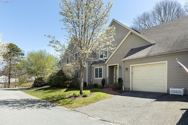 view of front of home featuring a garage and a front lawn