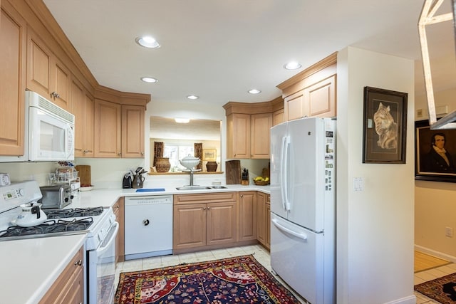 kitchen featuring light tile patterned floors, white appliances, light brown cabinetry, and sink