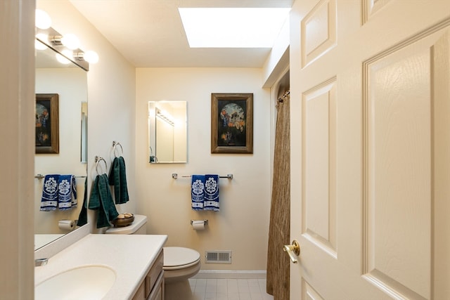 bathroom featuring vanity, toilet, and walk in shower