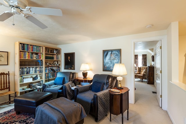 living room with light carpet and ceiling fan