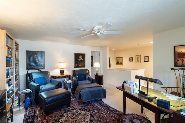 living room with dark carpet, ceiling fan, and a textured ceiling