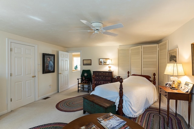 bedroom featuring ceiling fan and light carpet