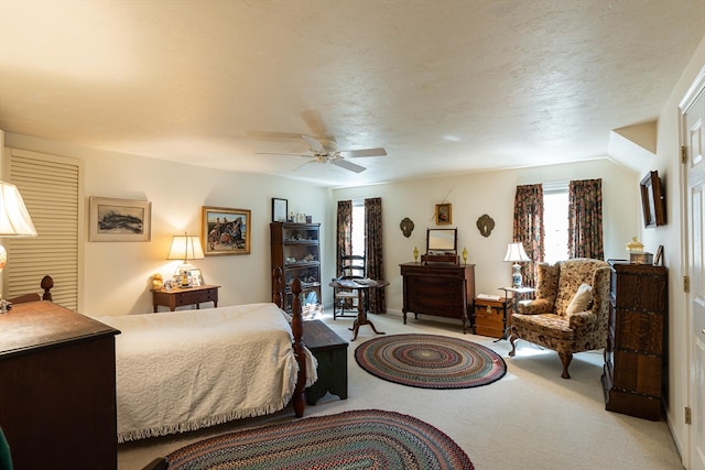 carpeted bedroom with a textured ceiling and ceiling fan