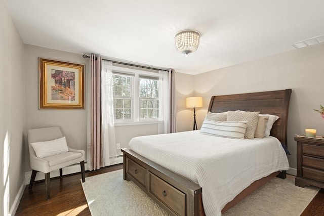 bedroom with dark wood-type flooring