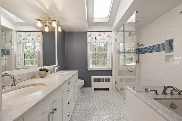 bathroom with radiator, a skylight, tile patterned flooring, walk in shower, and toilet