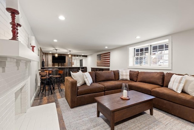 living room with a fireplace and light hardwood / wood-style flooring