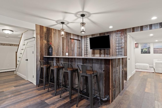 bar with white cabinetry, decorative light fixtures, and dark hardwood / wood-style flooring