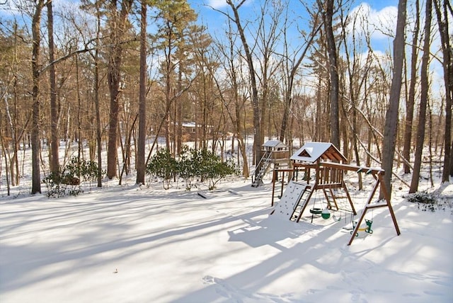 snowy yard with a playground