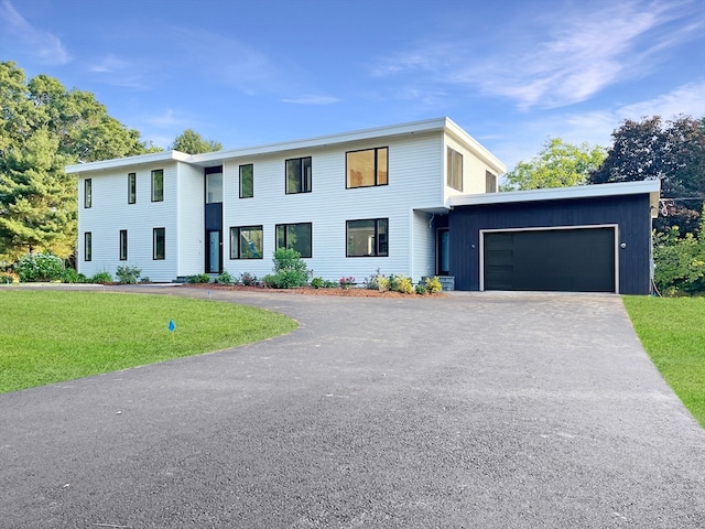 view of front of home with a front lawn and a garage