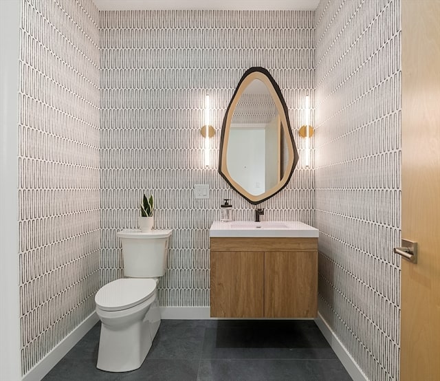 bathroom featuring tile flooring, tile walls, toilet, and vanity