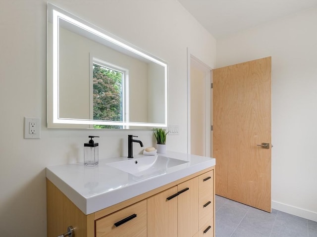 bathroom featuring tile patterned flooring and vanity