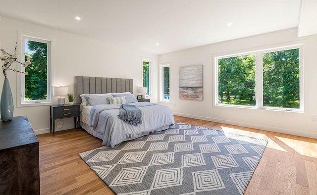 bedroom featuring recessed lighting, baseboards, and wood finished floors