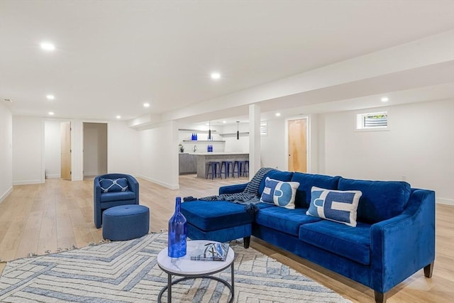 living room with light wood-style floors, recessed lighting, and baseboards