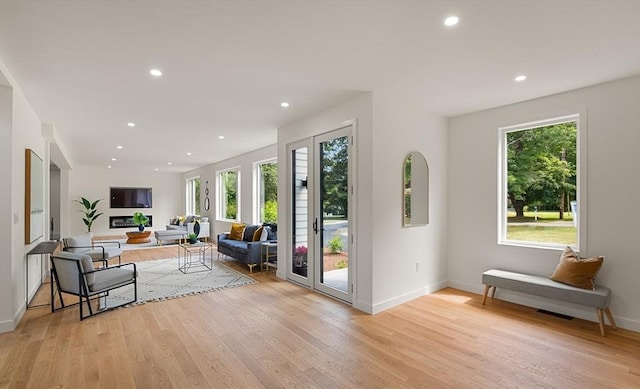 interior space with light wood-style floors, baseboards, and recessed lighting